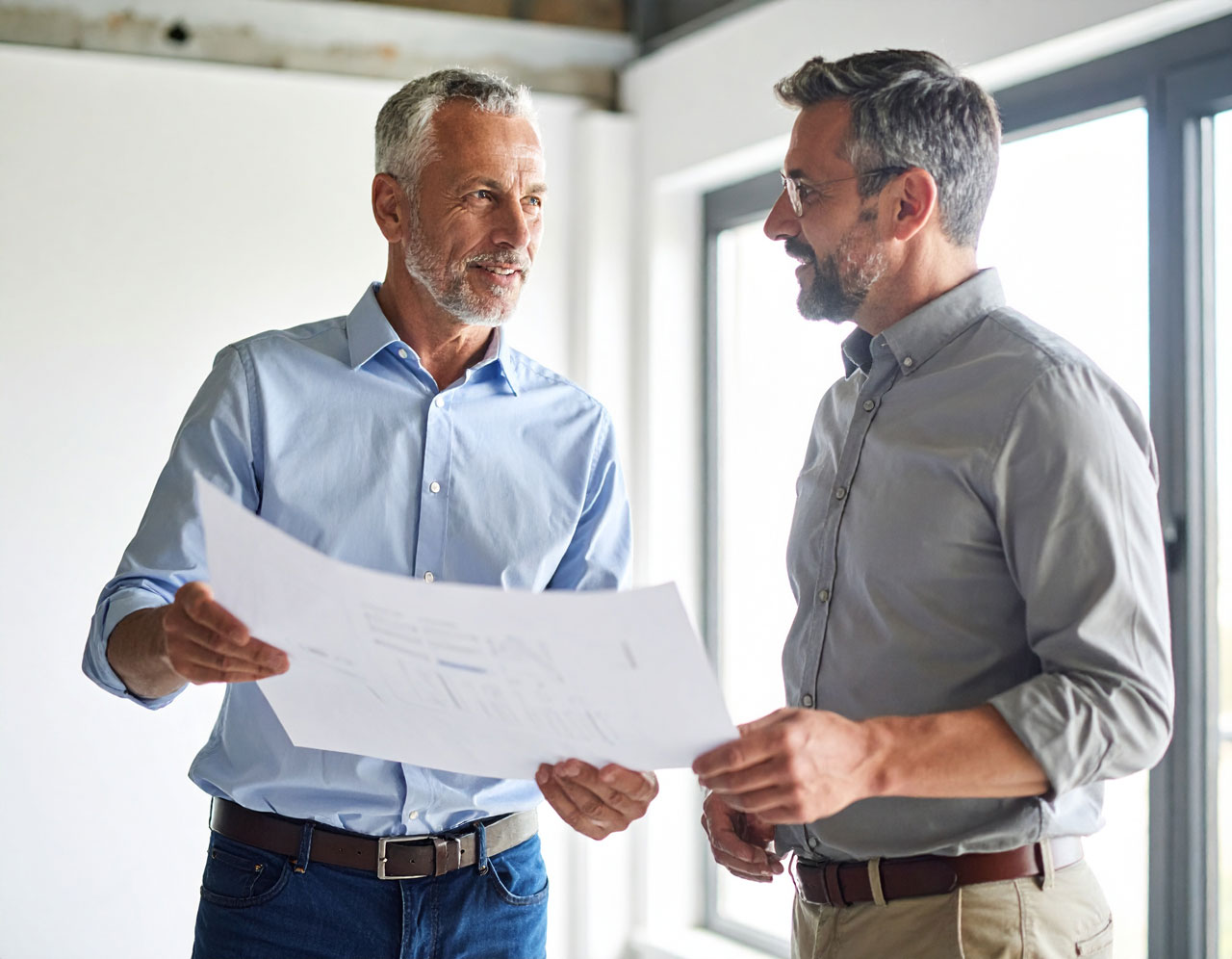 Two contractors reviewing the numbers on a project