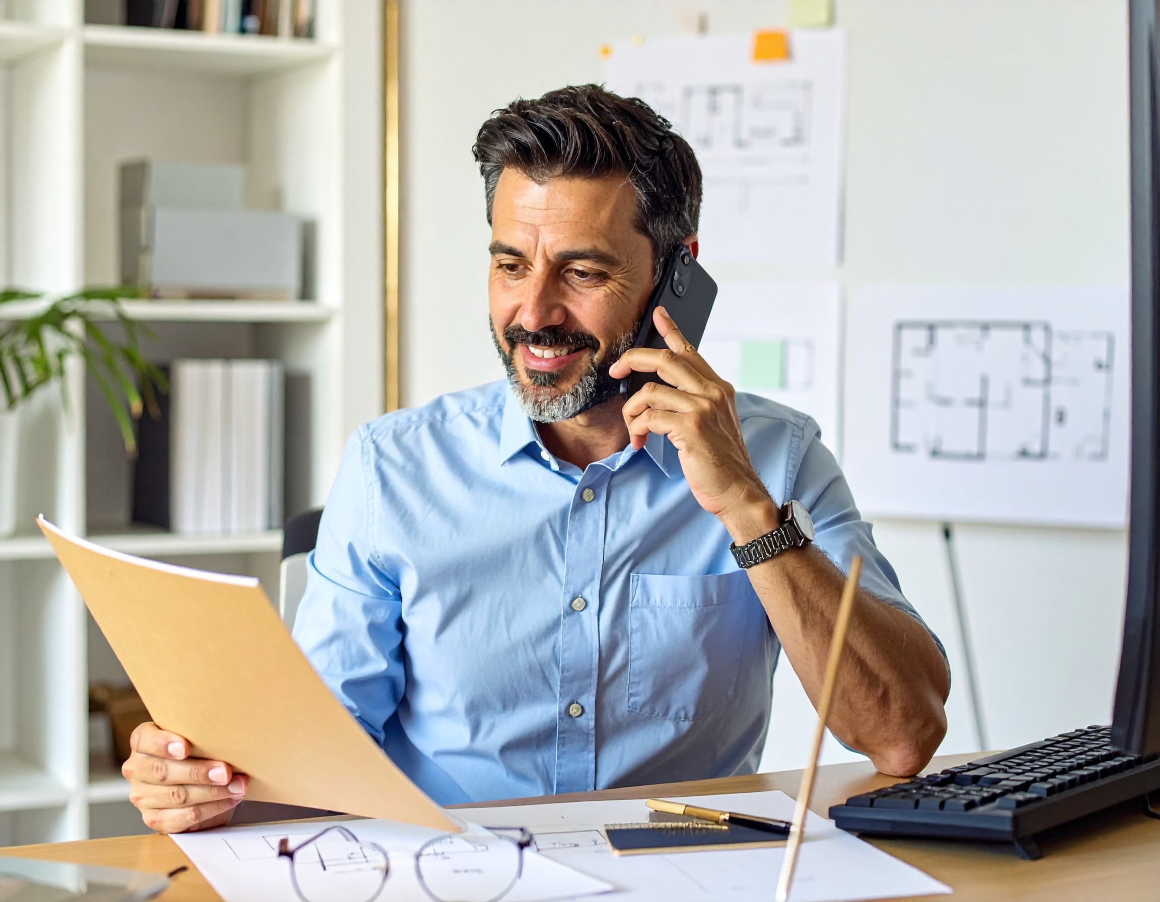 Contractor working at his desk reviewing marketing results