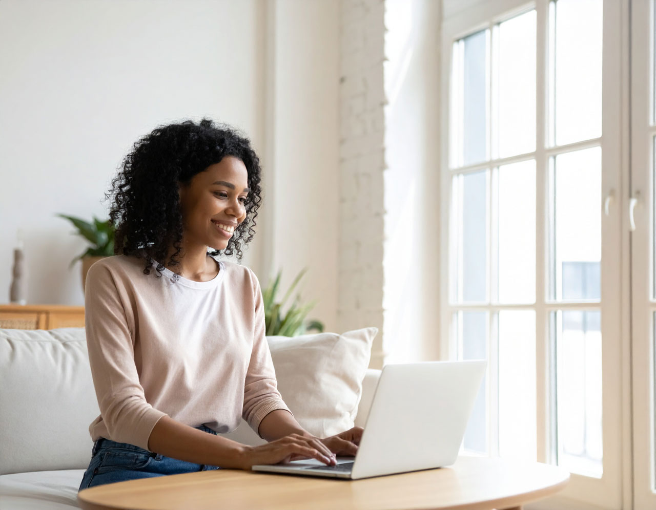 Homeowner researching contractors on a laptop at home